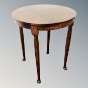 A 20th century circular occasional table in an oak finish.