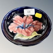 A Moorcroft pottery hibiscus shallow dish.
