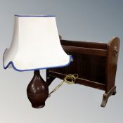 A magazine rack with lion mask handles together with a carved hardwood table lamp with shade