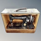 A 20th century cased Singer hand sewing machine.