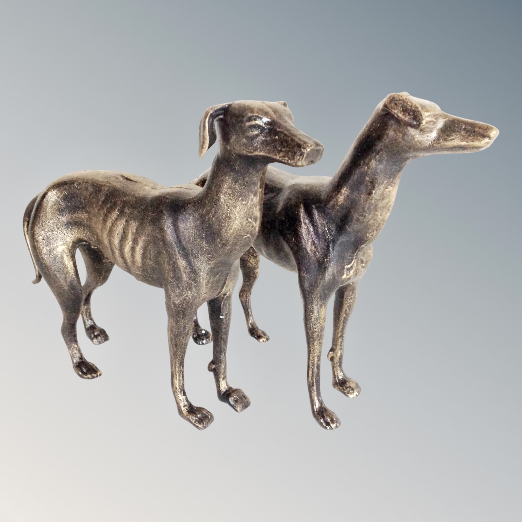 Two cast iron greyhound figures.