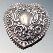 A silver heart shaped pill box.