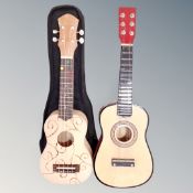 Two ukuleles, one in carry bag.