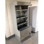 An Interlivin stainless steel refrigeration shelving unit with pull-down shutter door.