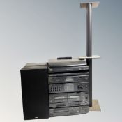 A Sanyo hifi system with speakers, remote and speaker stands.