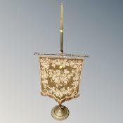 An antique brass and tapestry table pole screen.
