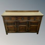 A Jaycee furniture oak triple door sideboard fitted with three drawers