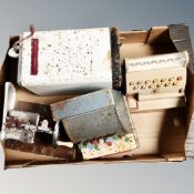 A box containing mid-20th century toy cash registers, sewing machine and Hoover washer.