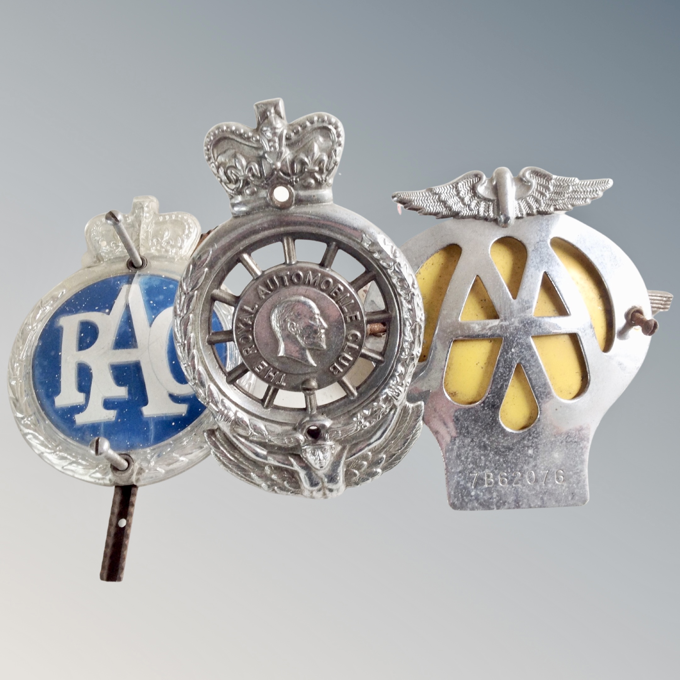 A vintage Royal Automobile Club car badge together with a further RAC and AA car badge.