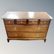 A Stag Minstrel four-over-two chest of drawers together with a torchere.