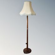 A 20th century beech wood standard lamp with shade.