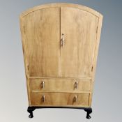 A 1930s walnut dome topped linen cabinet fitted with two drawers.