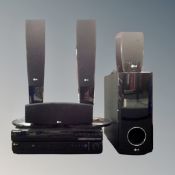 A Samsung DVD surround sound system together with a further LG DVD player, with remotes and leads.