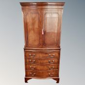 A Regency style mahogany double door cocktail cabinet on four drawer chest, fitted with slide.