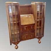 An Edwardian oak side by side bureau bookcase