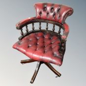 A Chesterfield red button leather swivel captain's chair.
