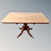 A 19th century mahogany pedestal breakfast table on brass capped feet.