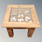 A contemporary pine display coffee table containing rock and shell samples.