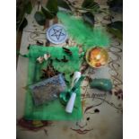 A ritual magic spell kit containing handmade votive, pentagram, incense, feather,
