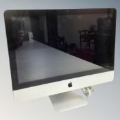 A 2011 Apple iMac, with power cable and mouse.