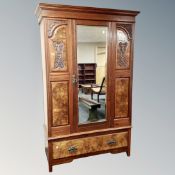 A late Victorian mahogany and walnut mirror door wardrobe fitted with a drawer.