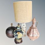 An antique Middle Eastern copper and brass jug, together with three assorted table lamps,