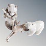 A Lladro figure of a polar bear together with a further Lladro donkey and a Nao panda with bamboo.