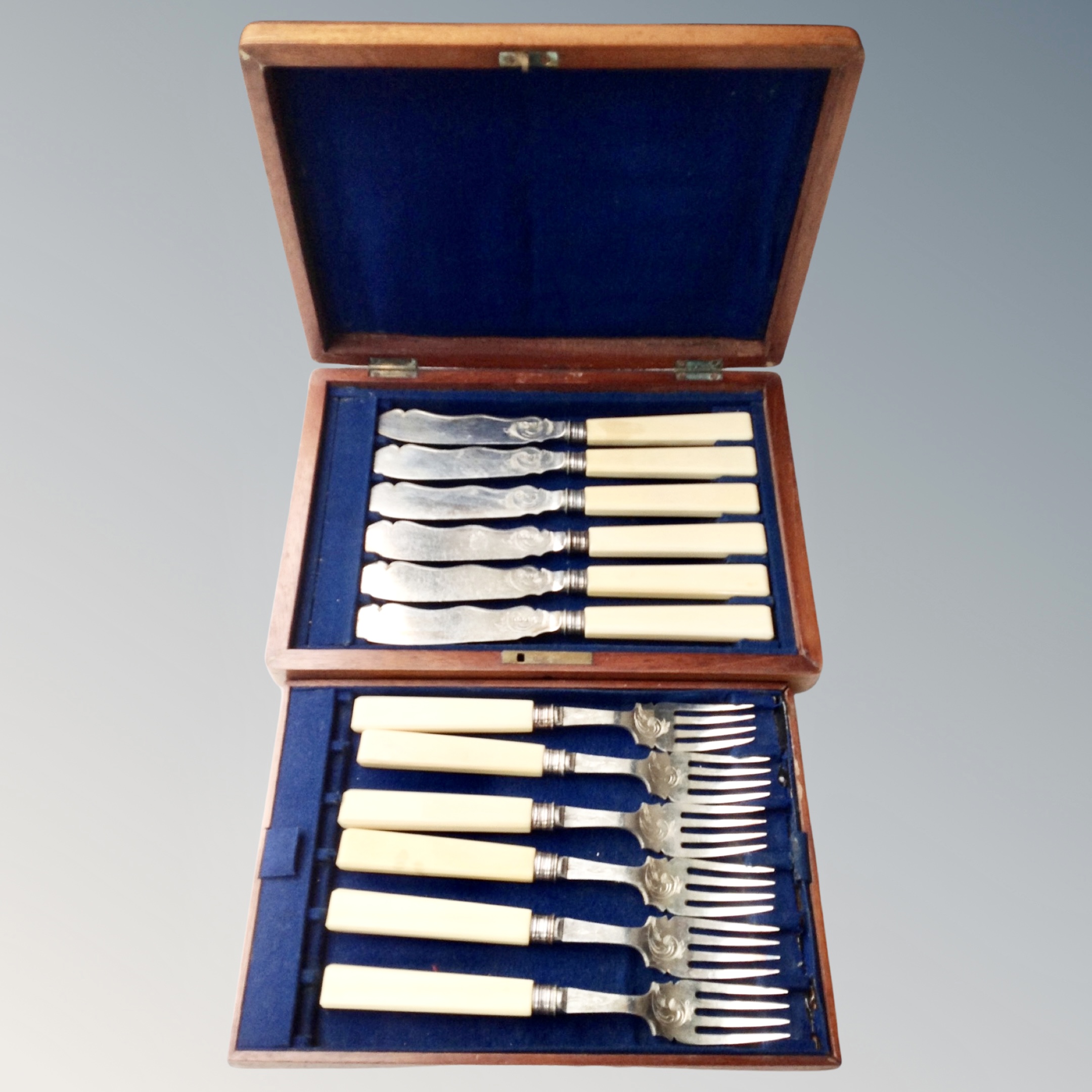 A canteen of Elkington plated cutlery together with an antique mahogany box of fish cutlery.