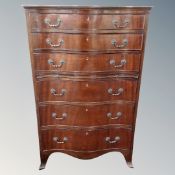 A Regency style six drawer serpentine fronted chest with slide.