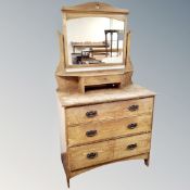 An oak arts and crafts three drawer dressing chest.