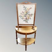 A 20th century oak framed tapestry fire screen together with an oak D-shaped hall table.
