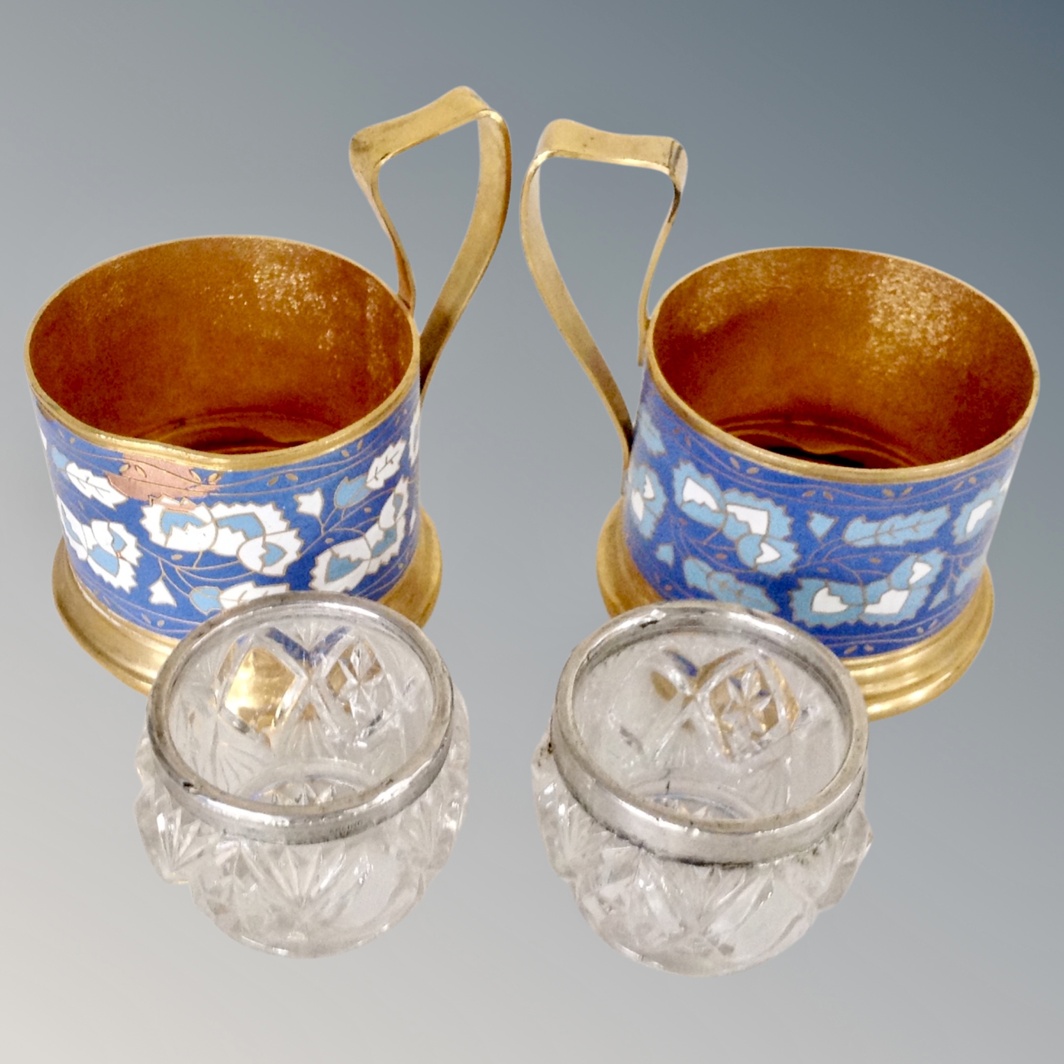 A pair of Russian cloisonne blue glass holders and pair of salts with silver rims