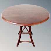 A circular occasional table on bentwood base.