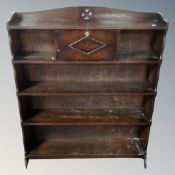 A set of 20th century oak open bookshelves fitted with fall front cupboard.