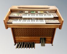An Orla Prestige teak electric organ (continental wiring)
