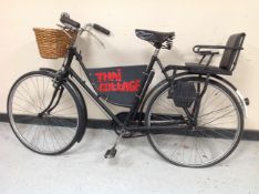 An early 20th century shopping bike with basket and child seat