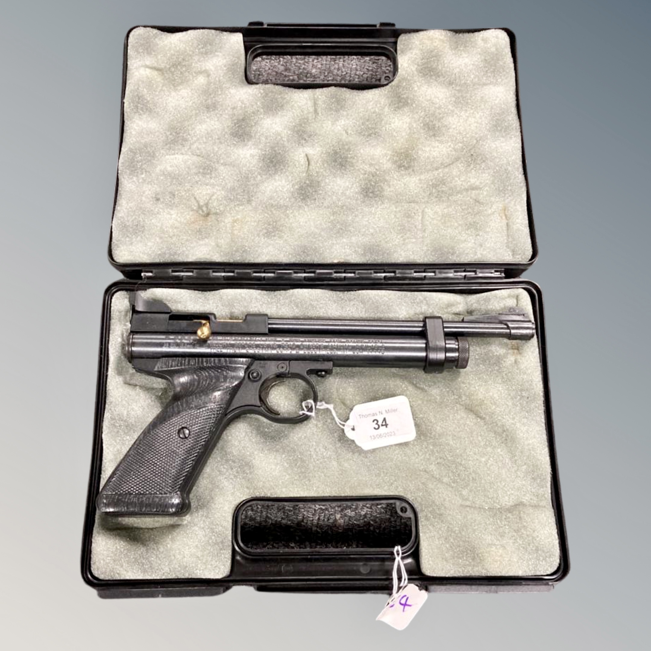 A Crosman .22 CO2 powered bolt action air pistol in hard carry case.