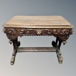 A Victorian oak centre table with Green Man carved decoration, fitted a drawer,