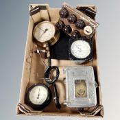 A box of industrial pressure gauges,