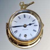 An Observer brass cased wall time piece with silvered dial and key,