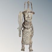 A Benin bronze figure depicting the Oba of Benin holding a sword,