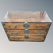A Japanese elm three drawer tansu chest with brass handles,