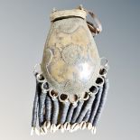 A West Africa Juju medicine bronze bag with shell decoration,