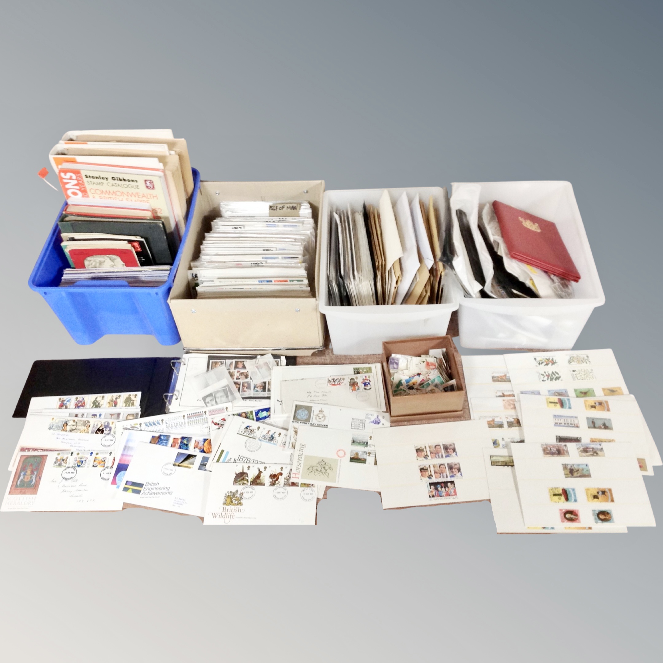 Four boxes of stamp collecting books and magazines, loose stamps,