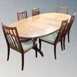 A mid century teak G-plan extending dining table together with six chairs