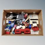 A box of office supplies, electric calculator, hole punch, bottles of ink,