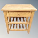 A light oak storage table fitted a drawer