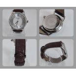 An Infinite Men's watch. and film on back, with chunky branded Infinite brown leather watch strap.