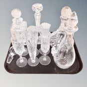 A tray of four cut glass lead crystal decanters together with a pair of champagne flutes and