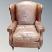 A brown leather antique style armchair